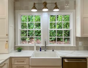 Two windows over a kitchen sink.