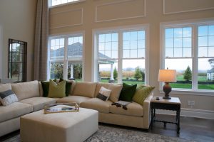 Living room with high ceilings and large windows.