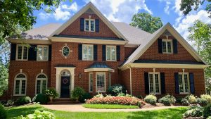 Large brick home with beautiful windows in several styles.